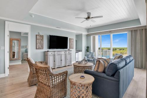 a living room with a blue couch and chairs at The Wharf 701 in Orange Beach