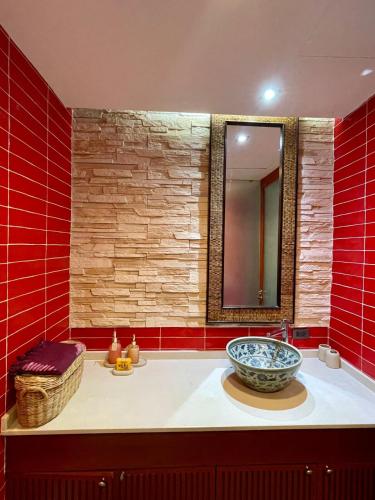 a bathroom with a sink with a large bowl at Panoramic sea view flat, overlooking Bang Bao in Ban Bang Bao