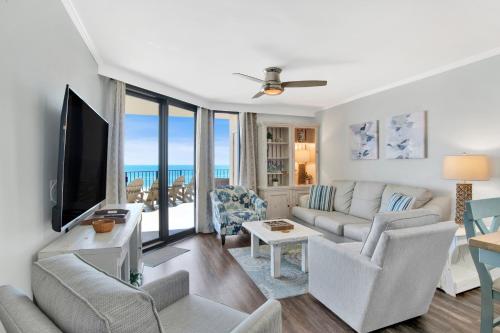 a living room with a couch and a tv at Phoenix III 3038 in Orange Beach