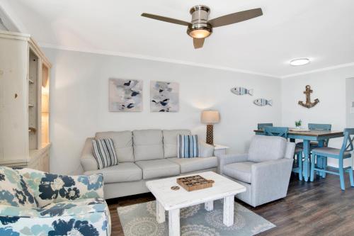 a living room with a couch and a table at Phoenix III 3038 in Orange Beach