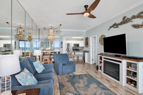 a living room with a couch and a flat screen tv at Phoenix East II 2154 in Orange Beach