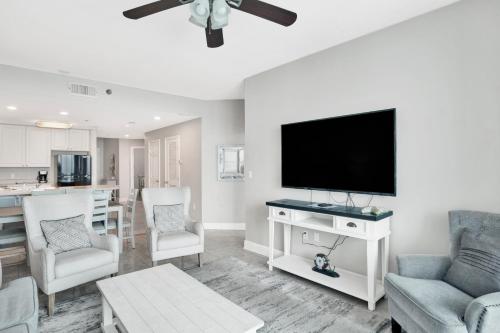 a living room with a flat screen tv on a wall at Lighthouse 1713 in Gulf Shores