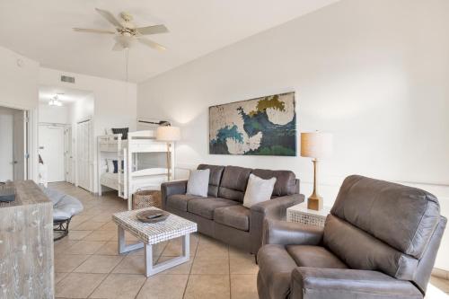 a living room with a couch and a chair at Phoenix V 014 in Orange Beach