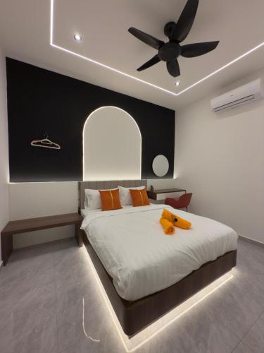 a bedroom with a bed with a ceiling fan at LYL 108 Private Pool Villa in Ipoh