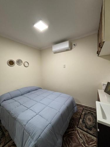 a bedroom with a blue bed in a room at Shanti Loft B in San Juan