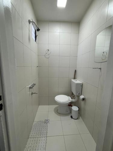 a white bathroom with a toilet and a shower at Shanti Loft B in San Juan