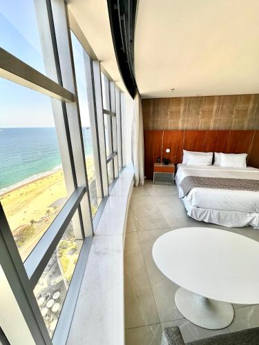 a bedroom with a bed and a view of the ocean at Hotel Nacional in Rio de Janeiro