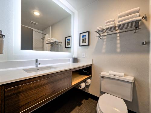 un bagno con lavandino, WC e specchio di Holiday Inn Tacoma Mall by IHG a Tacoma
