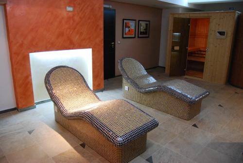 two wicker chairs in a room with a hallway at Aleksandar Villa & Spa in Ohrid