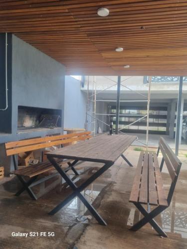 a picnic table and a bench in a room at El amparo in San Luis