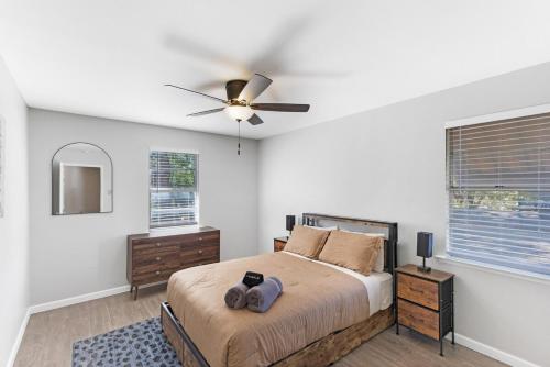 a bedroom with a bed and a ceiling fan at 5 min to AT&T Stadium, Game Room, Huge Yard in Arlington