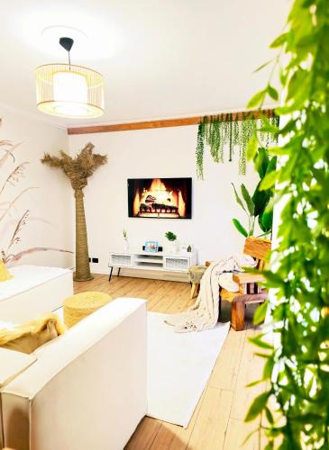 a living room with a couch and a fireplace at Premium Center Apartment in Durrës