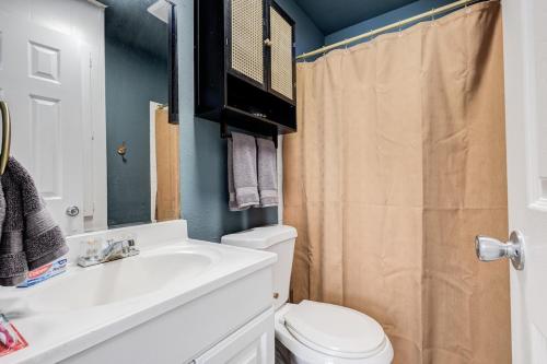 a bathroom with a white sink and a toilet at 5 min to AT&T Stadium, Game Room, Huge Yard in Arlington