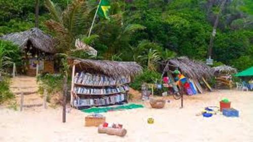 a book store on a beach with toys and buildings at Sonia Flats Pipa's Bay - Flat 211 in Pipa