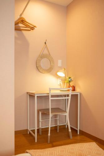 a white desk with a mirror and a chair at Villa El Sendero Sapporo in Sapporo