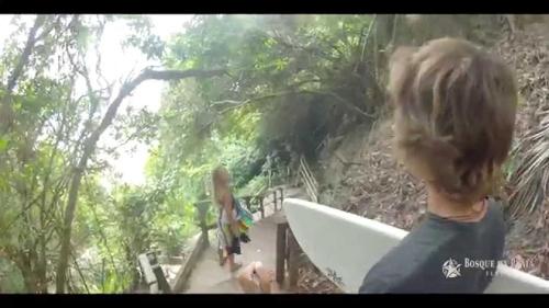 a person with a surfboard walking down a stairs at Sonia Flats Pipa's Bay - Flat 211 in Pipa