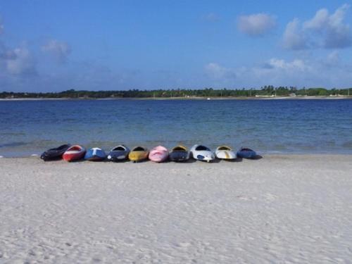 a group of kayaks lined up on the beach at Sonia Flats Pipa's Bay - Flat 211 in Pipa