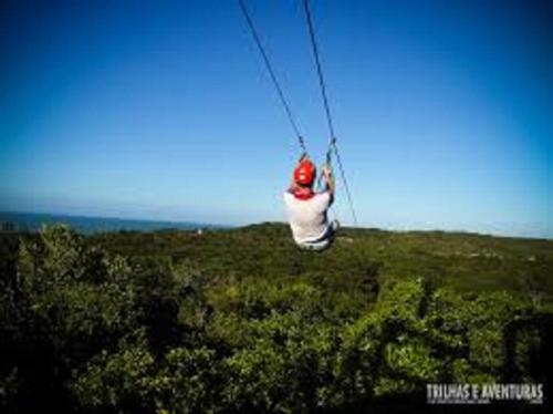 a person on a parachute in a field at Sonia Flats Pipa's Bay - Flat 211 in Pipa