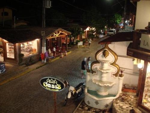 a motorcycle parked next to a street at night at Sonia Flats Pipa's Bay - Flat 211 in Pipa