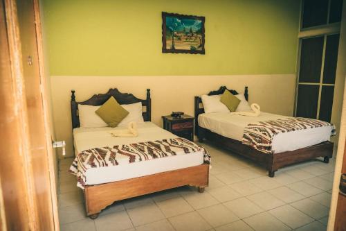 a bedroom with two beds in a room at Hotel Real in Chiapa de Corzo