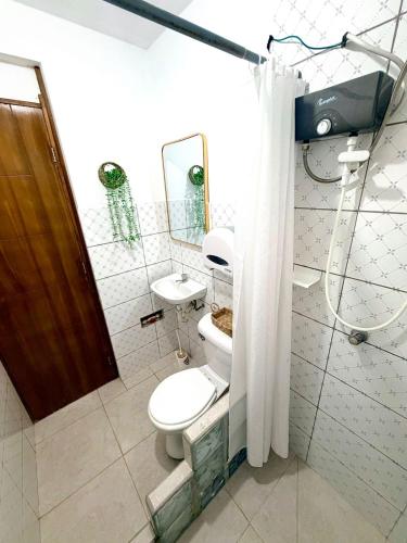 a bathroom with a toilet and a sink at Comfortable House in Punta Hermosa
