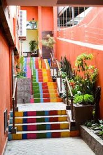 a staircase with a rainbow painted on the side of a building at Sonia Flats Pipa's Bay - Flat 211 in Pipa