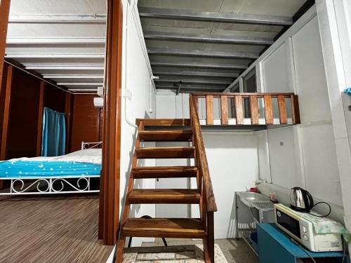 a room with a bunk bed and a ladder at Huen Him Bung in Chiang Rai