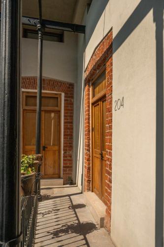 a brick building with a door and a balcony at Downtown Heritage Retreat CDMX in Mexico City
