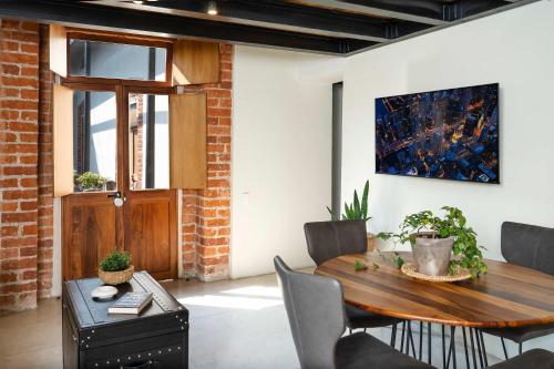 a dining room with a wooden table and chairs at Downtown Heritage Retreat CDMX in Mexico City
