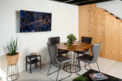 a dining room with a wooden table and chairs at Downtown Heritage Retreat CDMX in Mexico City