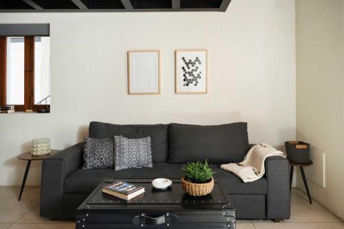 a living room with a gray couch and a table at Downtown Heritage Retreat CDMX in Mexico City