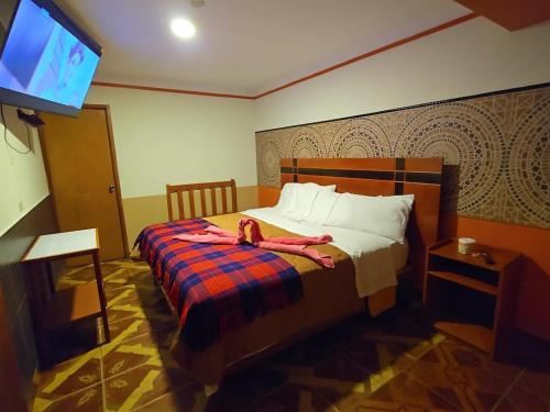 Llit o llits en una habitació de Hotel Manantial
