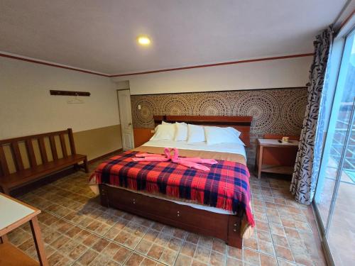 a bedroom with a bed with a pink bow on it at Hotel Manantial in Churín