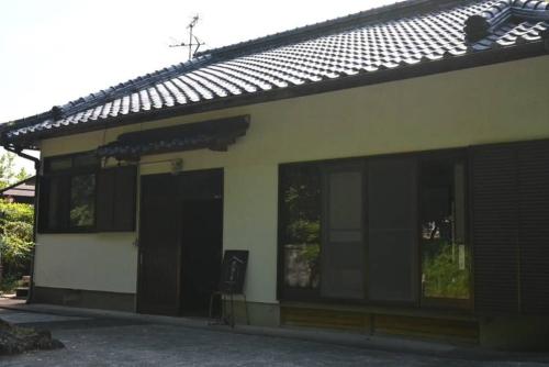 a building with large windows on the side of it at 一棟貸しの宿 黒潮の家 in Kuroshio