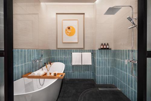 a bathroom with a tub and a sink at Cheong Fatt Tze - The Qing Suites in George Town