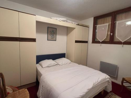 a bedroom with a large white bed in it at Appartement 4 Pers au Cœur de Super Besse - FR-1-814-142 in Super Besse