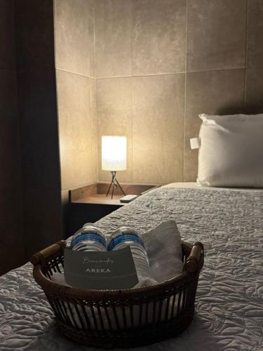 a basket filled with books sitting on a bed at Casa Areka in Veracruz