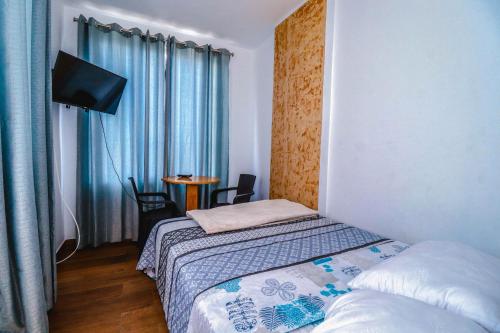 Ένα ή περισσότερα κρεβάτια σε δωμάτιο στο Cerro Azul Alojamiento