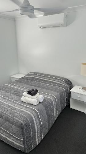 a bedroom with a bed with towels on it at The Mill Inn Tavern in Millmerran