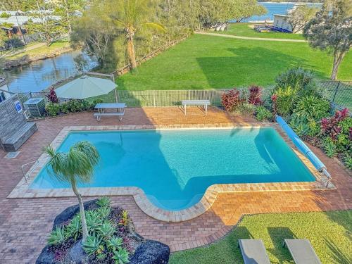 an overhead view of a swimming pool in a yard at Sails Resort Caloundra in Golden Beach
