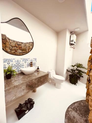 a bathroom with a sink and a mirror at Majestic View House in Curití