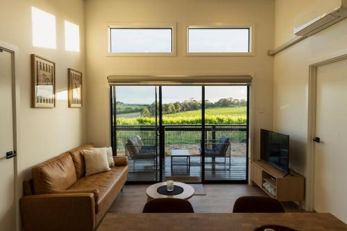 a living room with a couch and a television at Vineyard Villa in McLaren Vale