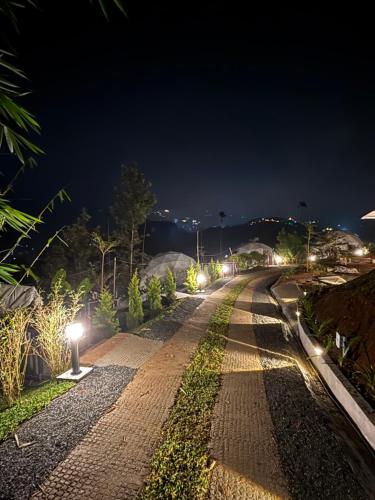 a long road at night with lights on it at Astara Munnar in Anachal