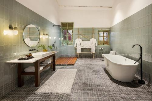 a large bathroom with a tub and a sink at Cheong Fatt Tze - The Townhouses in George Town