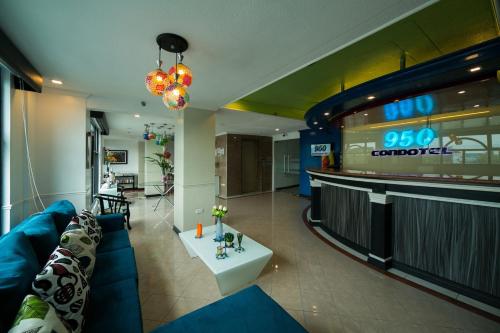 a living room with a blue couch and a bar at 950 Condotel in Angeles