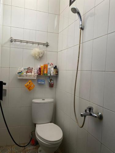 a bathroom with a toilet and a shower at De Adisucipto Homestay Syariah 2 in Ngadipuro