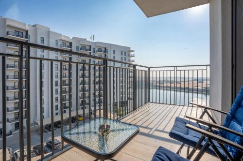 a balcony with a table and chairs on a balcony at Chic Studio l Waters Edge l Top Location in Yas island l Canal view with Balcony l Free Parking l Near Yas Mall l F1 Yas Island l Sea world in Abu Dhabi