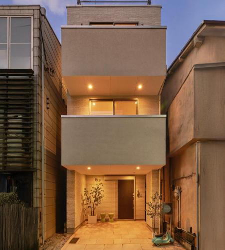 an external view of a house with a building at Mint House Ebisu - 3 Story, Artsy & Modern Home in Shibuya in Tokyo