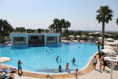 people in a swimming pool at a resort at Regiohotel Manfredi in Manfredonia