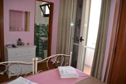 a bathroom with a table and a mirror and a sink at B&B Gi & Giò in Càbras